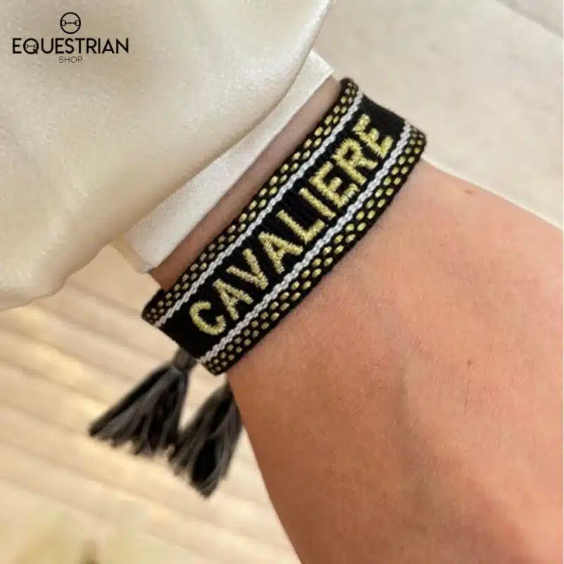 Bracelet Cavalière noir EQUESTRIAN SHOP en tissu brodé doré porté au poignet