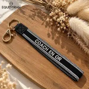 Porte-clés Coach en Or EQUESTRIAN SHOP noir avec inscription brodée et anneaux dorés